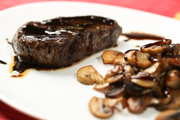 Meat slice with black sauce and mushrooms