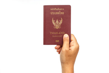 Hand holding Thailand passport isolated on white background