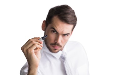 Focused businessman writing with marker