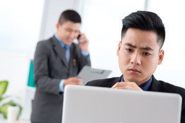 Serious Vietnamese manager