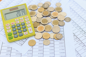 Close up calculator and coin on the table