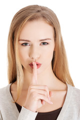 Naklejka premium Portrait of a woman making silence gesture