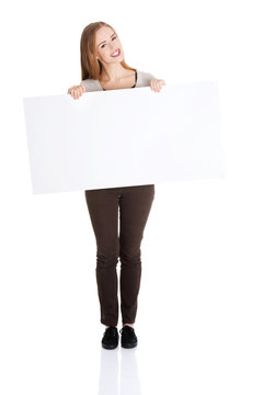 Full Length Happy Woman Holding An Empty Baner