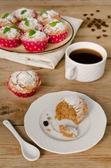 Muffins with coffee on wooden background