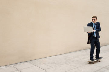 Businessman on skateboard © DragonImages