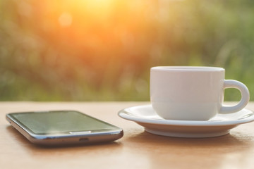 Fototapeta na wymiar A cup of coffee and smartphone on the table
