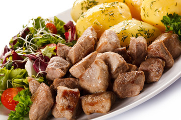 Grilled meat with boiled potatoes and vegetables