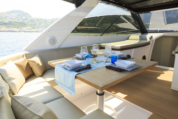 Fototapeta na wymiar lunch on motor yacht, Table setting at a luxury yacht.
