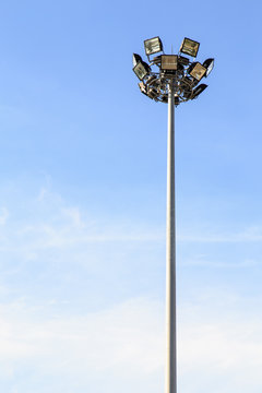 Spot light pole with blue sky in the stadium
