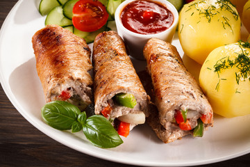 Wrapped pork chop, boiled potatoes and vegetables