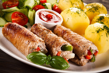 Wrapped pork chop, boiled potatoes and vegetables