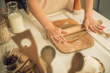 Obraz na płótnie Canvas Womans hands kneading dough on the table