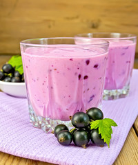 Milkshake with blackcurrants on napkin and board