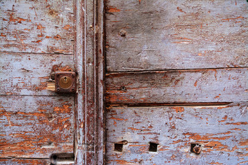 rusty keyhole in a wooden door