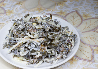 Seaweed salad with egg and onion on kitchen table