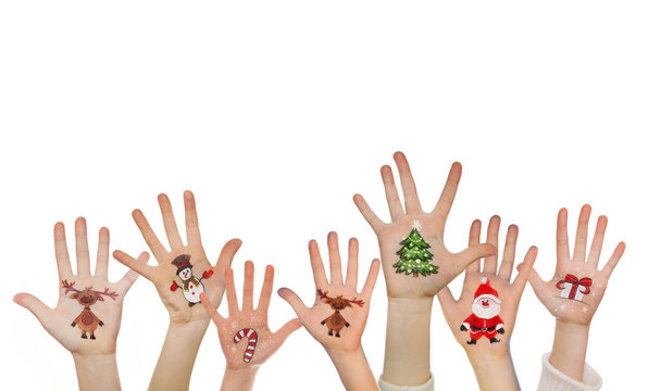 Childrens hands raising up with painted Christmas symbols