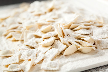 Fototapeta na wymiar Flour On Raw Ravioli Pasta At Counter