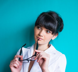 Beautiful woman posing while biting glasses pin