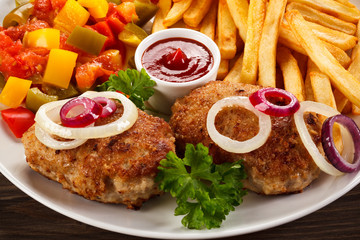 Fried chops, French fries and vegetable salad