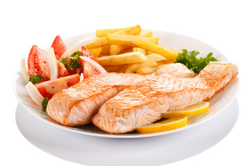 Grilled salmon and vegetables on white background