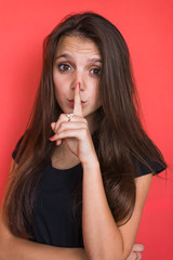 Secret woman. Female showing hand silence sign