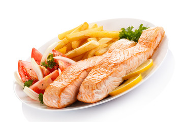 Grilled salmon and vegetables on white background