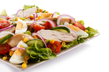 Roast chicken fillet and vegetables on white background