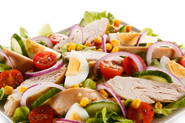 Roast chicken fillet and vegetables on white background