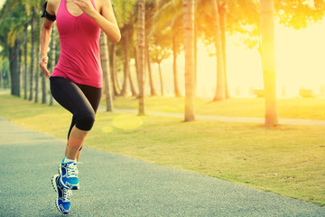 woman runner athlete running at tropical park