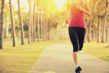 woman runner athlete running at tropical park