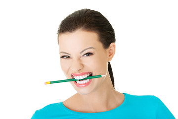 Portrait of a woman biting her pencil