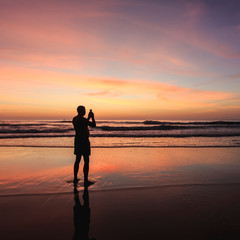 Fototapeta premium Silhouette of tourist at sunset beach in Phuket Thailand