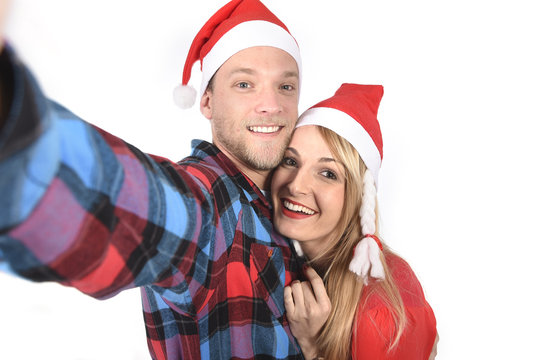 young couple taking Christmas love selfie mobile picture