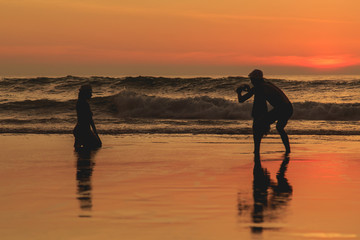 Silhouette of tourist at sunset beach in Phuket Thailand