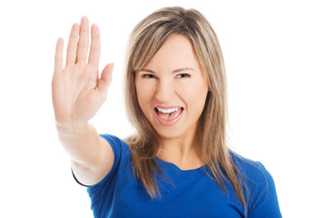 Portrait of a woman gesturing stop sign