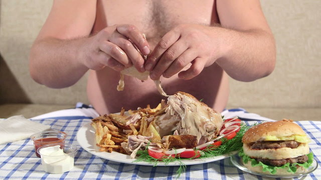 Hungry person eating fat dinner at home