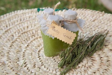 Rosemary body scrub and several rosemary twigs