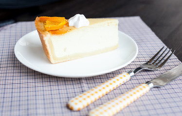 Cheesecake Dessert decorated with oranges and meringue