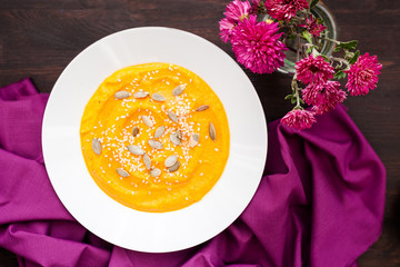 Pumpkin cream-soup with seeds in a plate