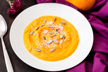 Pumpkin cream-soup with seeds in a plate