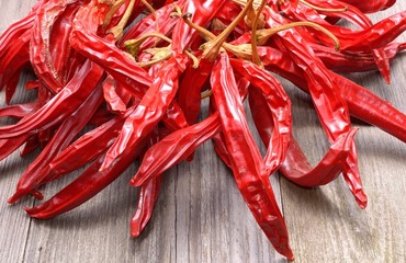 Dry red hot chilli peppers on wooden background