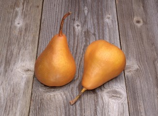 Two kaiser pears on wooden background