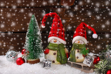 christmas decoration with santa figurines on wooden background