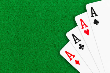 Four aces poker playing card on green felt background