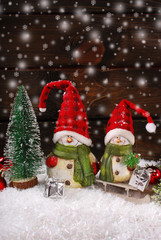 christmas decoration with santa figurines on wooden background