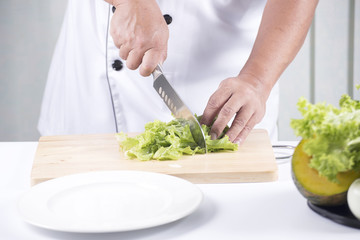 Chef cutting lettuce
