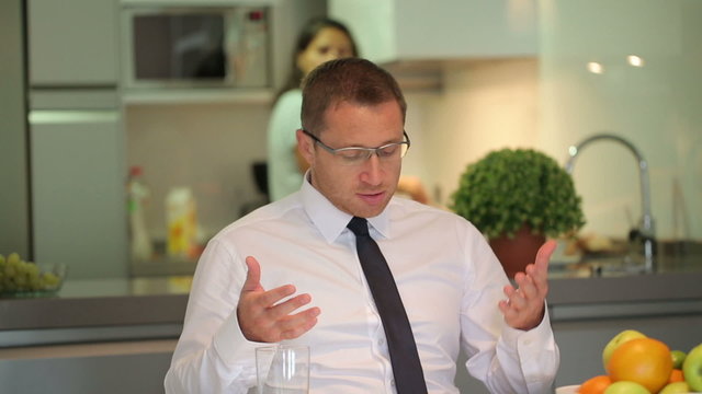 Impatient businessman waiting for breakfast and shouting on wife