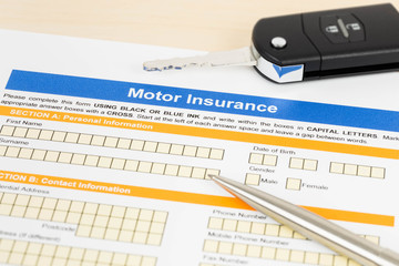 Motor or car insurance application with pen and car key