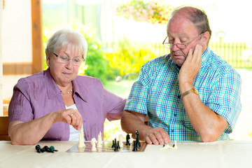 senior couple playing chess