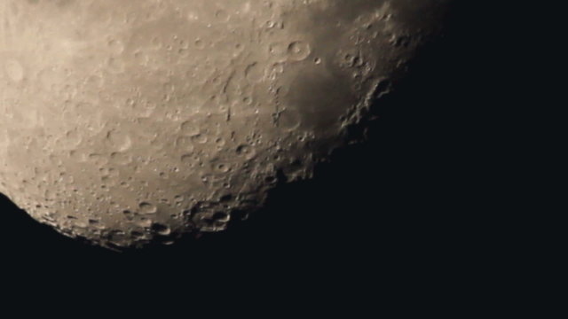 The moon with light clouds, close up view, strong zoom
